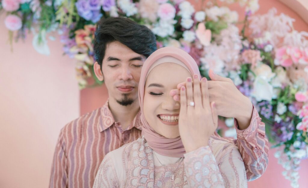 A happy couple in traditional clothing, celebrating their wedding day with love.